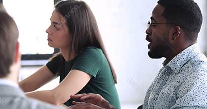 Young female worker agreeing with biracial male colleague.