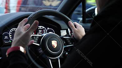 Man driving new Porsche Cayenne
