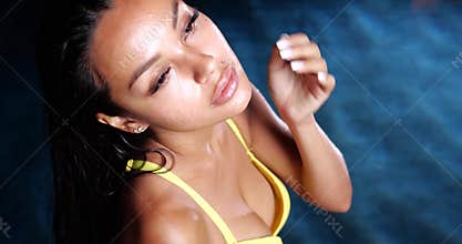 Sexy woman in the swimming pool at night