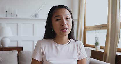 Happy young vietnamese woman holding video call.