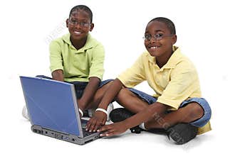 Brothers Working On Laptop Computer Sitting On Floor