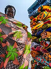 Ghana woman looking at various fabrics