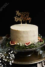 Vertical shot of a  happy birthday dream cake with white cream with a black background