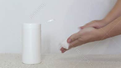 A man rubs his hands with a wet disinfectant wipe on a white background. The concept of antiseptic wipes against