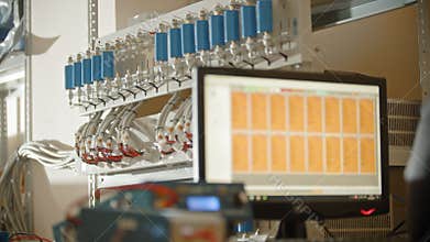 Production plant - the production of li-ion batteries - putting the batteries on the stand and measures the voltage