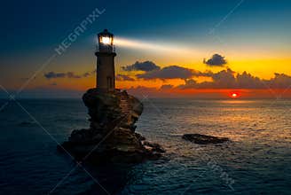 The beautiful Lighthouse Tourlitis of Chora at night. Andros island, Cyclades, Greece