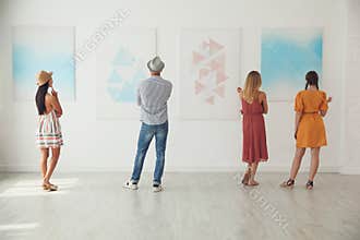 Group of people at exhibition in art gallery