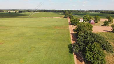 Countryside with farm fields and a dirt road. Aerial view.