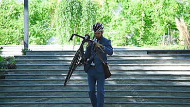 Businessman Carries A Bicycle Up Stairs To Work.