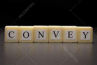 The word CONVEY written on wooden cubes isolated on a black backgrond