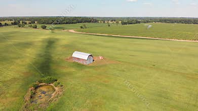 Countryside with fields ,old barn and small pond. Aerial view.