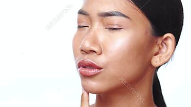 Closeup face of beautiful Asian woman looking at the camera doing different expressions over white