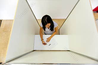 Woman in a voting booth