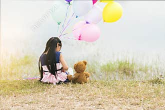 Happy Child hug teddy bear hold air balloon in green park playground. Teddy bear best friend for little kids cute girl. Autism
