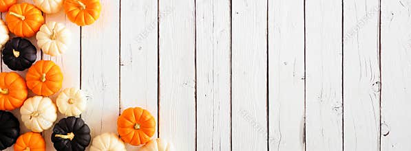 Autumn pumpkin corner border in Halloween colors orange, black and white against a white wood banner background