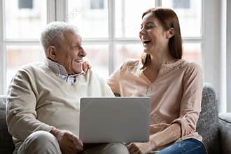 Overjoyed old 70s retired father watching funny movie with daughter.