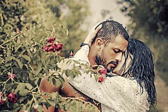 Love in the garden. Passionate couple in the garden hugging.