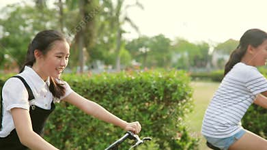 Asian teenager riding bicycle in home village