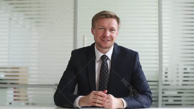 Smiling businessman coach waving hand talking looking at camera