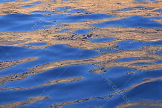 Abstract golden reflection blue water shapes
