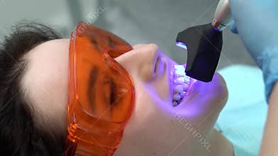 Pretty woman`s teeth treatment in dental clinic
