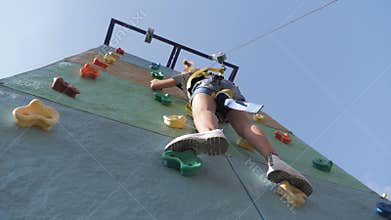 Active young girl on adventure park, training climbing. Child to pass difficult section of an obstacle course. Active