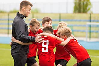 Coaching Youth Sports. Kids Soccer Football Team Huddle with Coach
