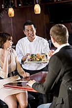Japanese sushi restaurant, chef serving customers