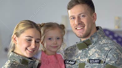 Smiling military couple and daughter looking camera, national pride, patriotism