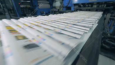 Printed magazines are moving along the transporter. Printing newspapers in typography.