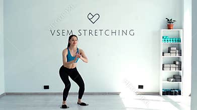 Fitness trainer smiling and doing squats with gliding discs in slow motion