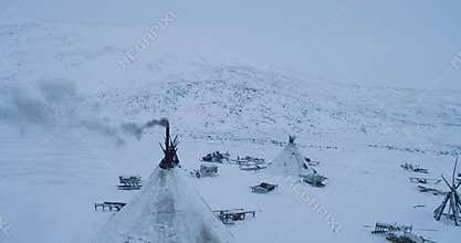 Capturing from the top with drone a camp of yurts in Yamal many sleigh outside the yurts amazing view.