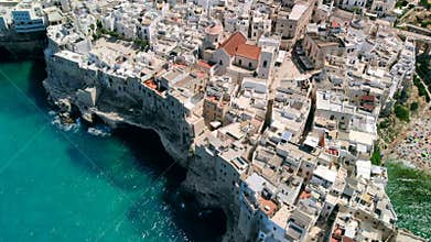 Flying over rooftops of Italian city of Polignano a Mare , Apulia