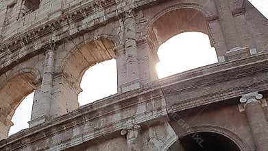 A ray of sun passes through the arches of the Colosseum in Rome, Italy.