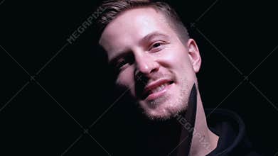 Smiling maniac threatening victim with knife, isolated on black background