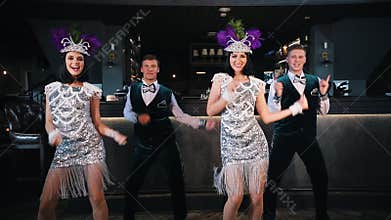 Theme party - Young smiling people in glistening retro clothes dancing