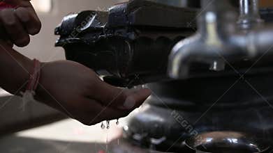Cleansing Hands and Mala in Fountain Spout