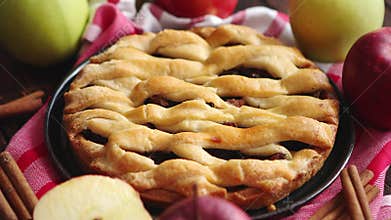 Homemade pastry apple pie with bakery products on dark wooden kitchen table