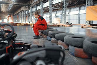 Go kart racer sitting on tires, karting auto sport