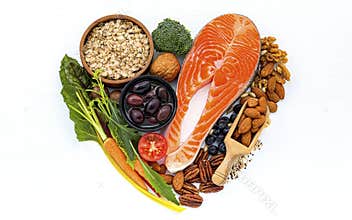 Heart shape of ingredients for healthy foods selection on white wooden background