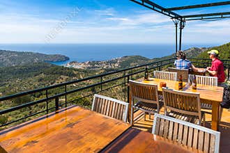 Tables in restaurant overlooking the bay of Port de Soller on the west coast of Majorca. Spain