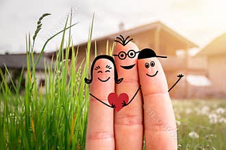 Family moving into a new home concept: Painted finger family in front of a blurry house