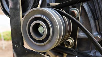 Belt drive roller rotates on agricultural machine. Belt drive