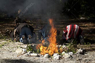 Three mayan priests bowing in prayer