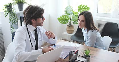 Doctor discussing about medical report with woman