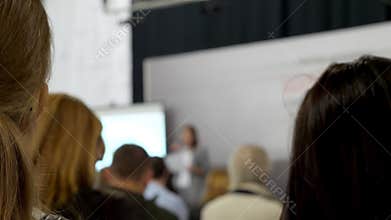Business Speaker talking Conference with audience. Businesswoman couch on the studying seminar.