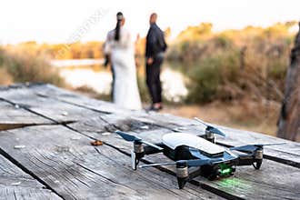 Drone standing on the table with wedding couple in nature