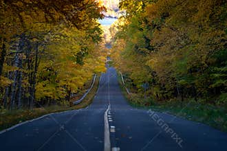 Road through the Porcupine Mountains in the Upper Peninsula in Michigan during the fall. Concept for fall leaf peeping road trip