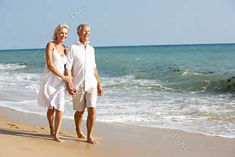 Senior Couple Enjoying Beach Holiday In The Sun