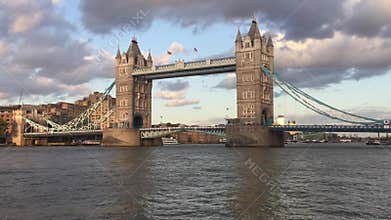 Tower Bridge, London, skyline at sunset with Thames river lights reflected on river, famous London landmark